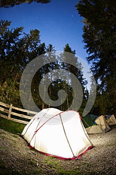 Evening lit tent in camping