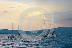 Evening Mediterranean landscape. Yachts and fishing boats on water. Montenegro