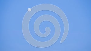 Evening moon with plane passing from