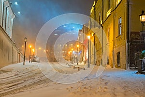 Winter night landscape, evening in the night snowy street under snowfall
