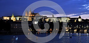 Summer night view of Charles Bridge over the Vltava in the historical part of Prague