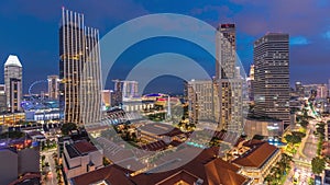 Evening panorama with Marina Bay area and skyscrapers city skyline aerial day to night timelapse.