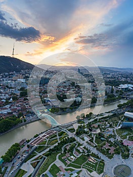 The evening panorama of the old town in the old district of Avlabari, Holy Trinity Cathedral and Rike Park, the Kura river