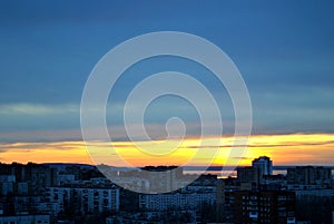 Evening panorama of residential areas of the city of Togliatti against the backdrop of a beautiful winter sunset.