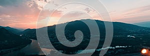 Evening panoramic view of Mtskheta city and Kura river from Jvari monastery at sunset