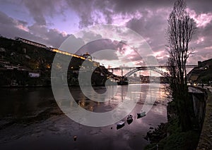 Evening in Porto. View of the bridge and the river Duoro. Night illumination of the city. Portugal