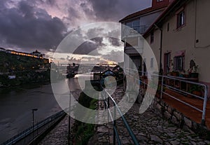 Evening in Porto. View of the bridge and the river Duoro. Night illumination of the city. Portugal