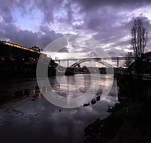 Evening in Porto. View of the bridge and the river Duoro. Night illumination of the city. Portugal