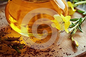 Evening primrose flower and seeds with a jar of evening primrose oil