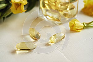 Evening primrose oil capsules on a white table