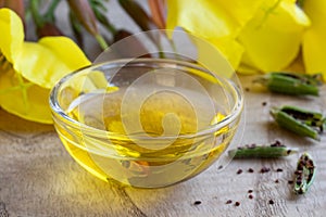 Evening primrose oil with evening primrose flowers and seeds