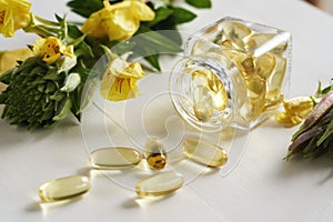Evening primrose oil in gel capsules in a glass bottle