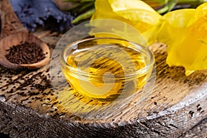 Evening primrose oil, seeds and flowers on a table