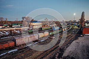 Evening railway. Commodity trains, freight wagons and cisterns