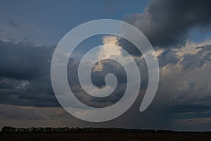 Evening rain clouds in the field. Spring season