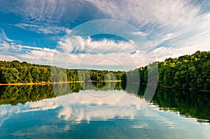 Evening reflections of clouds and trees in Lake Marburg, Codorus State Park, Pennsylvania. photo