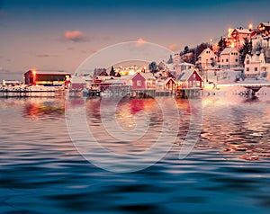 Evening Reine town reflected in the calm waters of Norwegian sea, Norway, Europe.