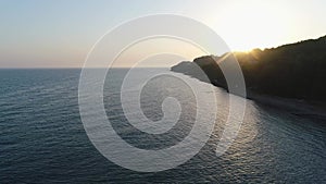 Evening sea, aerial view. Seashore against the backdrop of the sunset