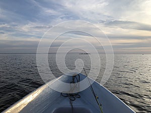 evening sea, boat with a fishing rod