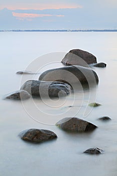 Evening sea shore, water and stones on a beach in Gdynia, Poland