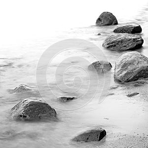 Evening shore sea water and stones on a beach