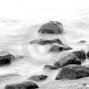 Evening shore sea water and stones on a beach