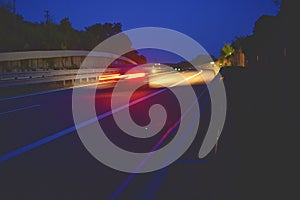 Evening shot of trucks doing transportation and logistics on a highway. Highway traffic - motion blurred truck on a highway motorw