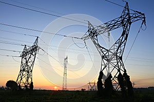 In the evening, the silhouette of high voltage towers