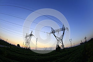 In the evening, the silhouette of high voltage towers