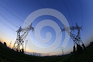 In the evening, the silhouette of high voltage towers