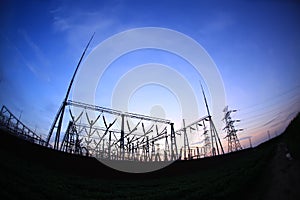 In the evening, the silhouette of high voltage towers