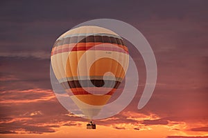 Evening sky background with white dramatic clouds and hot air balloon