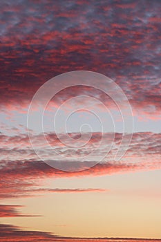 Assorted red and pink colored clouds at sunset