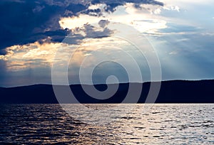 Evening sky with dramatic clouds over the sea. Dramatic sunset over the sea.