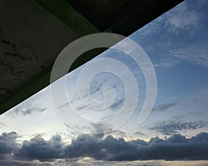 the evening sky with the expanse of clouds partially covered by the roof