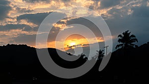 evening sky photography Sunset, bright light, blue sky with clouds blocking the sun.