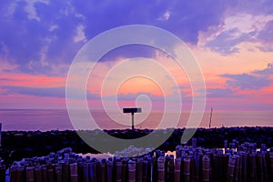 Evening sky,rows of bamboo sticks in the sea and cement bridge near Matchanu Shrine,Phanthai Norasing,Mueang Samut Sakhon District