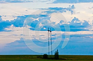 Evening sky. Sunset in the field. Power transmission line