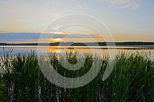 Evening landscape with the setting sun over the lake