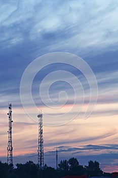 Evening summer landscape with two high-rise telecommunication towers