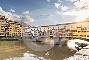 Evening sun against Ponte Vecchio, the historic old bridge over Arno river in Florence, Tuscany, Italy is popular
