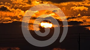 Evening sun hidden between the dark cloud.