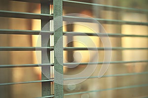 Evening sun light outside wooden window blinds, sunshine and shadow on window blind, decorative interior in home