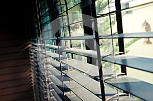 Evening sun light outside wooden window blinds, sunshine and shadow on window blinds , decorative interior home