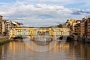 Evening sun over Ponte Vecchio, the historic old bridge over Arno river in Florence, Tuscany, Italy is popular tourist