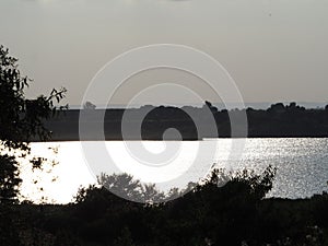 The evening sun rests on the waters of the ivars lake and vila sana, lerida, spain, europe