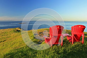 Evening Sun Shining on Red Adirondack Chairs at East Point on Saturna Island, Gulf Islands National Park, British Columbia, Canada