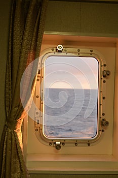 evening sunlight through the porthole of a ship