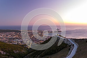 Evening sunset scenic view of Gelendzhik resort city from hill of caucasian mountains. City district, sky horizon and