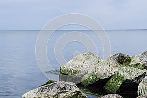 Evening sunset at the sea with a stony shore